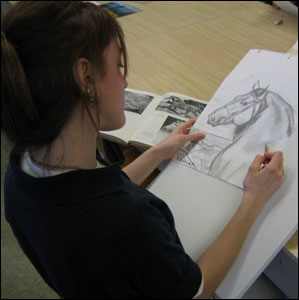 Student shows sketch completed in art class.